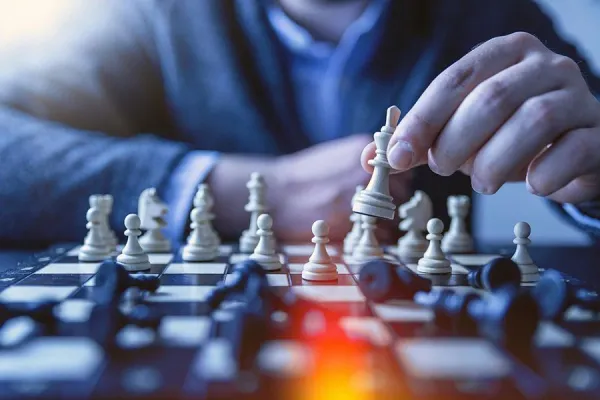 POV sitting at the black side of a chess board while an opponent makes the first move