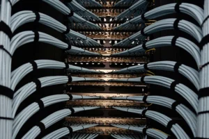 Ethernet cables going into the back of a rack of network switches